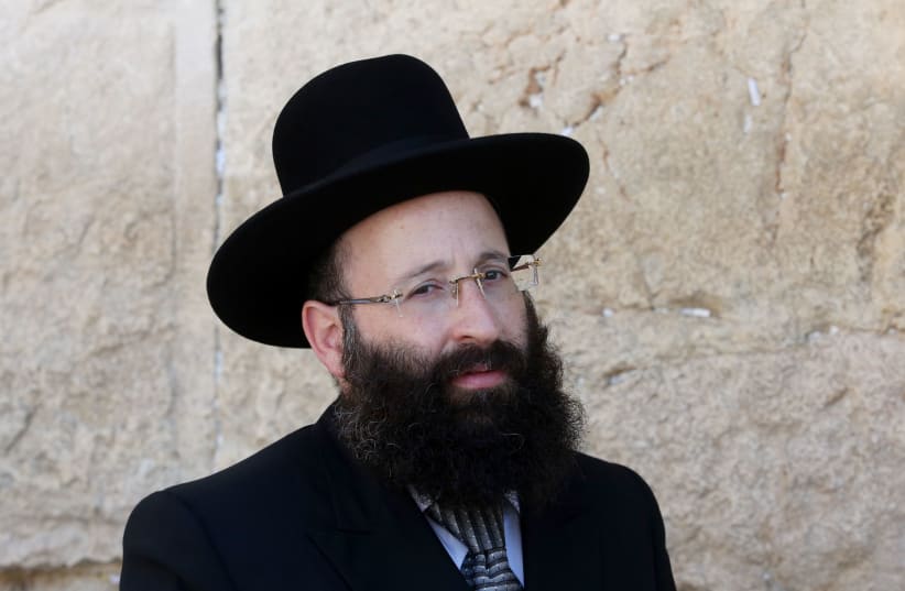 Rabbi Shmuel Rabinowitz, Rabbi of the Western Wall, poses for a photo in front of the holy site (photo credit: MARC ISRAEL SELLEM/THE JERUSALEM POST)