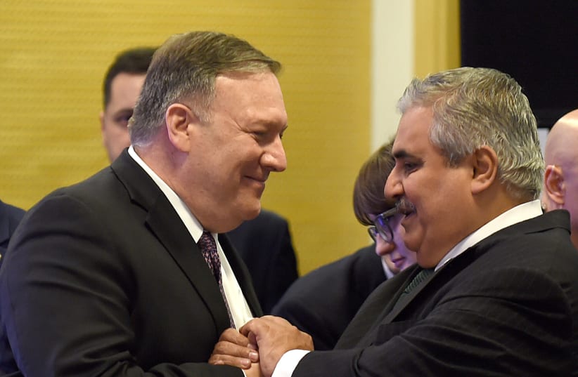 US Secretary of State Mike Pompeo (L) greets Bahrain Foreign Minister Khalid bin Ahmed al-Khalifah before a working lunch at the conference on Peace and Security in the Middle East in Warsaw, on February 14, 2019 (photo credit: JANEK SKARZYNSKI / AFP)