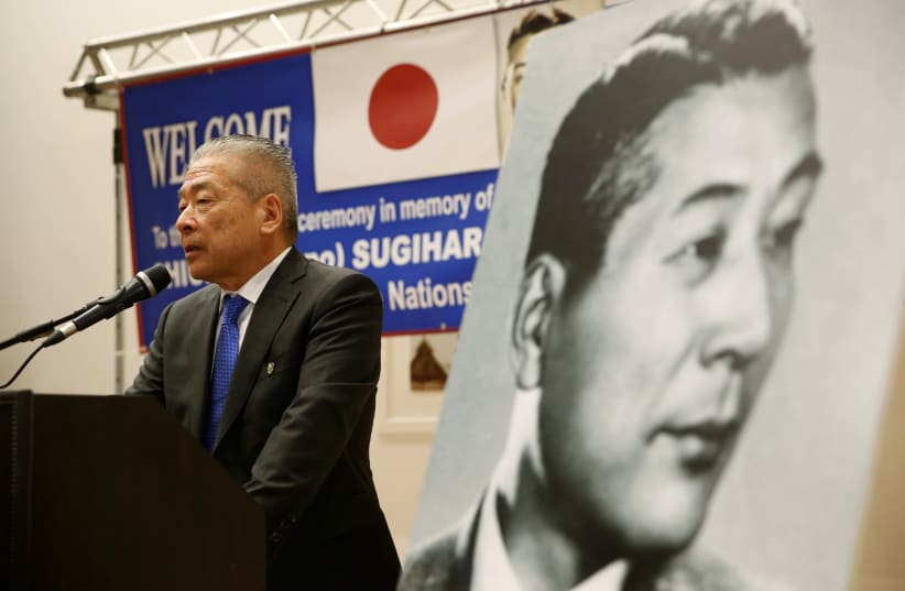 Nobuki Sugihara, son of Japanese diplomat, Chiune Sugihara (depicted in black and white picture), who helped saved thousands of Lithuanian Jews in World War 2, speaks during a street-naming ceremony in honour of his father in Netanya, Israel June 7, 2016. (photo credit: BAZ RATNER/REUTERS)