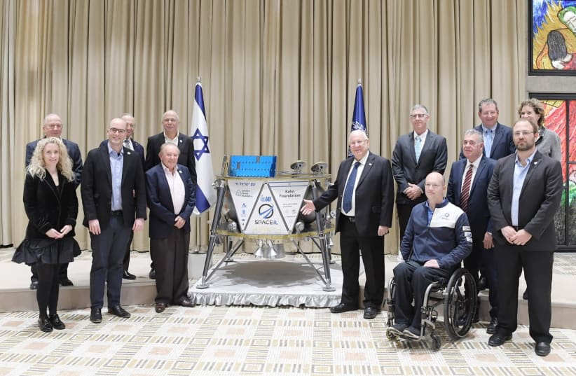 Reuven Rivlin (C) at a ceremony with a probe that will be sent to the moon, February 17th, 2019 (photo credit: AMOS BEN-GERSHOM/GPO)