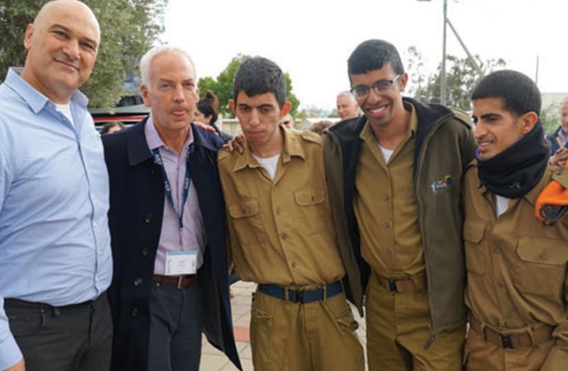 Tiran Attia, Director of Special in Uniform, and Jeff Farber, CEO of the Koret Foundation, with soldiers serving in Special in Uniform (photo credit: YOSSI KAHANA)
