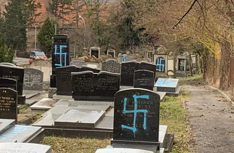 Gravestones at the Jewish cemetery in Quatzenheim, France, vandalized with Nazi graffiti, February 19. (photo credit: CONSISTOIRE OF THE LOWER RHINE)