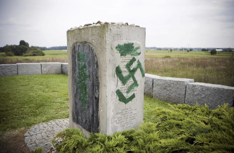 A monument with Nazi swastikas painted over it in Jedwabne (photo credit: AGENCJA GAZETA VIA REUTERS)