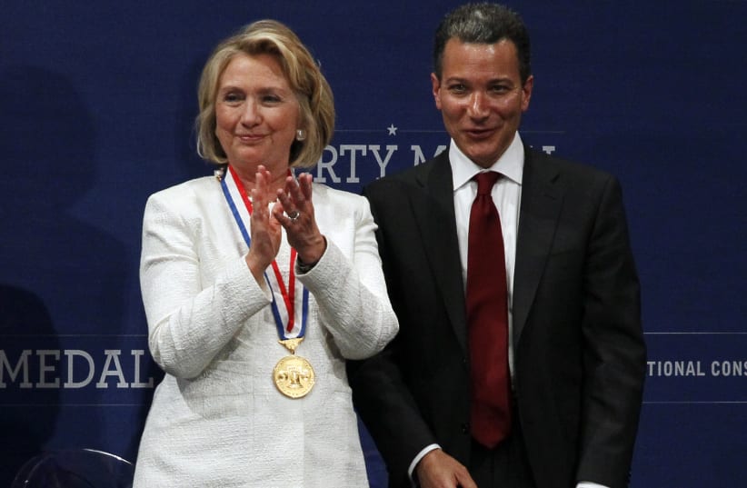 Former U.S. Secretary of State Hillary Rodham Clinton (L) applauds after being awarded the 2013 Liberty Medal by Jeffrey Rosen (R), president and CEO of the National Constitution Center, during a ceremony in Philadelphia, Pennsylvania September 10, 2013 (photo credit: TOM MIHALEK / REUTERS)