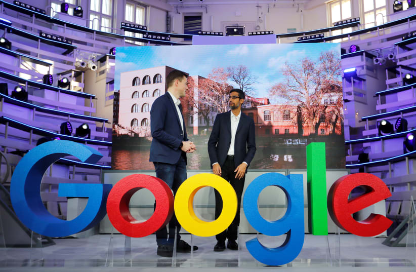 Google CEO Sundar Pichai and Philipp Justus, Google Vice President for Central Europe and the German-speaking Countries, stay at a Google logo during the opening of the new Alphabet's Google Berlin office in Berlin, Germany, January 22, 2019. (photo credit: HANNIBAL HANSCHKE/REUTERS)