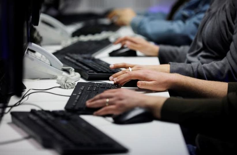 Employees, mostly veterans of military computing units, use keyboards as they work at a cyber hotline facility at Israel's Computer Emergency Response Centre (CERT) in Beersheba, southern Israel (photo credit: REUTERS/AMIR COHEN)
