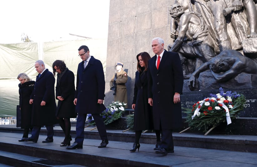 The monument to the Ghetto Heroes in Warsaw, after a wreath-laying ceremony last week attended by (right to left): US Vice President Mike Pence and his wife, Karen; Polish Prime Minister Mateusz Morawiecki and his wife, Iwona; and Prime Minister Benjamin Netanyahu and his wife, Sara (photo credit: REUTERS)