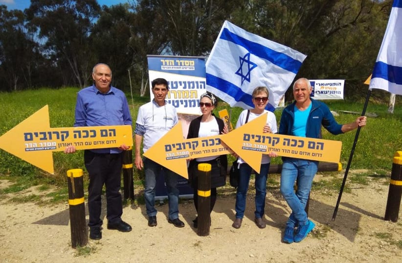 The parents of fallen IDF Lt. Hadar Goldin with Members of Knesset hold signs reading "they're this close" at a protest near the Gaza border, calling for the bodies of their son and another IDF soldier to be returned (photo credit: MISDAR HADAR)