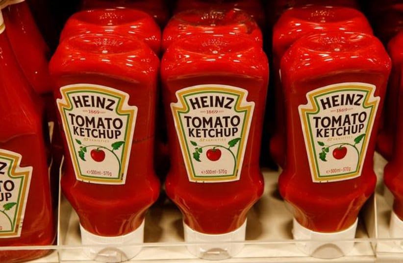 Bottles of Heinz tomato ketchup of U.S. food company Kraft Heinz are offered at a supermarket of Swiss retail group Coop in Zumikon, Switzerland (photo credit: REUTERS/ARND WIEGMANN)