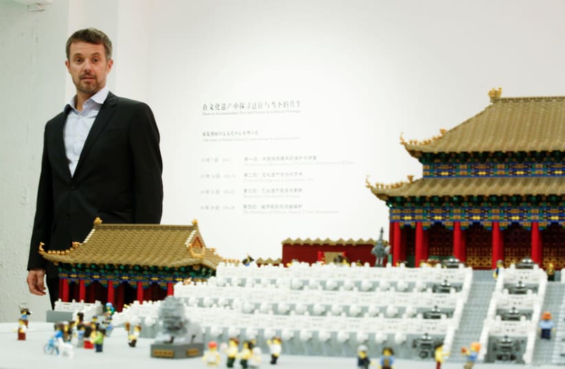 Danish Crown Prince Frederik looks at a model of the Forbidden City made of Lego bricks at the Danish Cultural Center at the 798 art district in Beijing, China, September 23, 2017. (photo credit: REUTERS/THOMAS PETER)