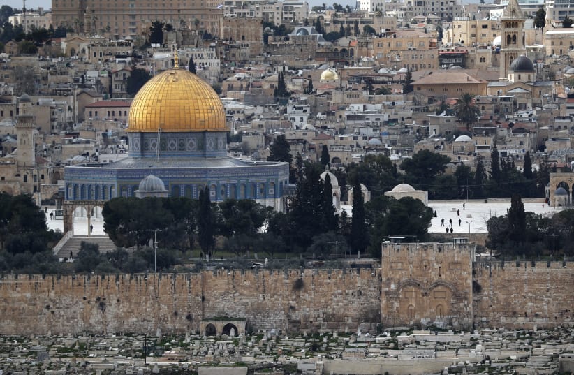 The Golden Gate also known as the Mercy Gate (R) and the Dome of the Rock at the Al-Aqsa mosques compound in Jerusalem's Old City (photo credit: THOMAS COEX / AFP)