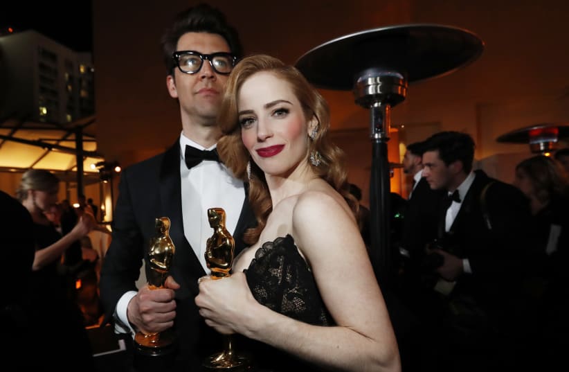 Guy Nattiv and Jaime Ray Newman with their awards for Best Live Action Short Film for the film "Skin," February 24, 2019 (photo credit: MARIO ANZUONI/REUTERS)