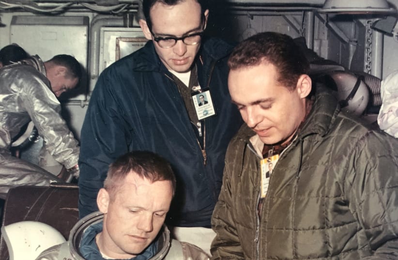 Neil Armstrong (foreground) inspects space suit gloves with Dr.Gerald Ahronheim (R) and NASA flight surgeon Dr. Ken Beers (photo credit: DR. GERALD AHRONHEIM)