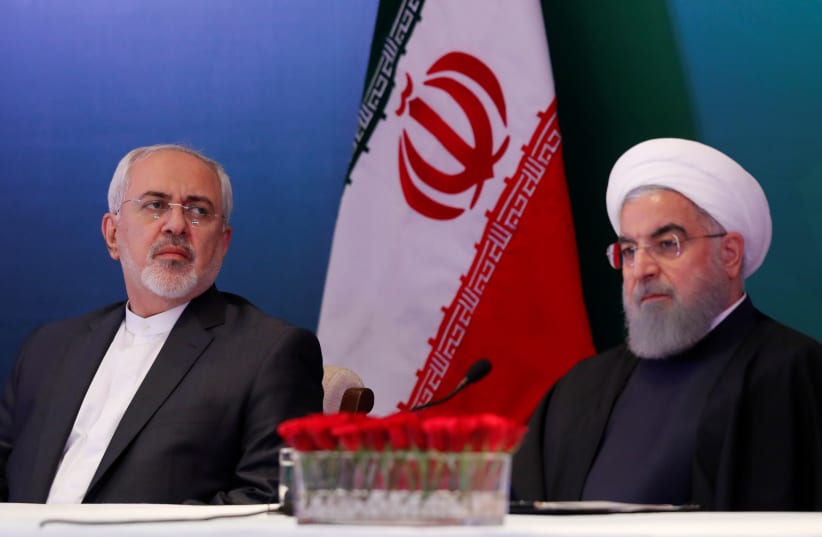 Iranian President Hassan Rouhani (R) and Foreign Minister Mohammad Javad Zarif attend a meeting with Muslim leaders and scholars in Hyderabad, India, February 15, 2018 (photo credit: DANISH SIDDIQUI/ REUTERS)
