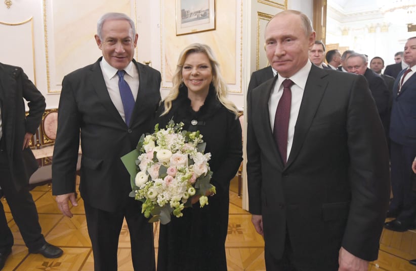 PRIME MINISTER Benjamin Netanyahu and his wife, Sara, enjoy a moment with Russian President Vladimir Putin on Wednesday (photo credit: HAIM ZACH/GPO)