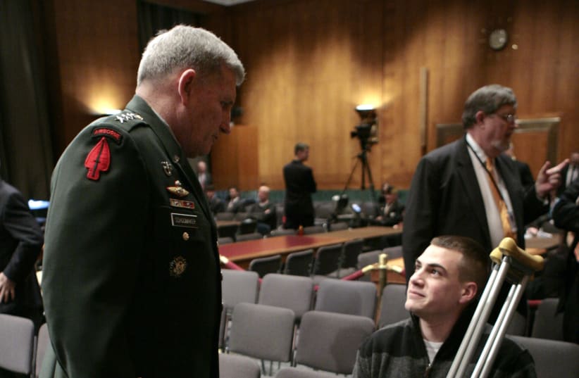 U.S. Army Chief of Staff Gen. Peter Schoomaker (L) talks with amputee Aaron Schoenfeld, a Marine veteran from Navarre, Florida, at a hearing by the Senate Armed Services Committee on Capitol Hill in Washington about conditions at Walter Reed Army Medical Center March 6, 2007. Schoomaker's brother, M (photo credit: REUTERS)
