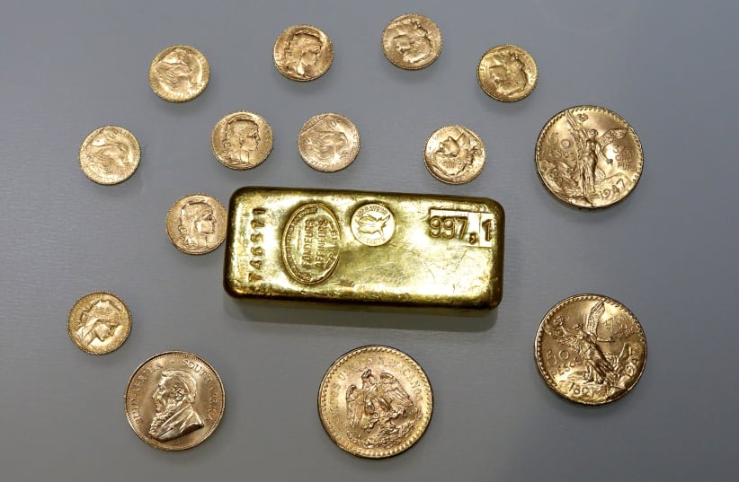 A gold ingot and gold coins are seen in this illustration picture taken November 17, 2017. (photo credit: ERIC GAILLARD/REUTERS)