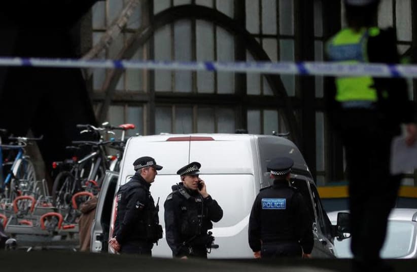 Police officers secure a cordoned off area at Waterloo station near to where a suspicious package was found, in London, Britain (photo credit: REUTERS/PETER NICHOLLS)