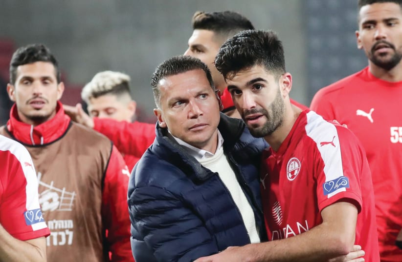 Hapoel Beersheba coach Barak Bachar (center) congratulates his players after the club recorded its third consecutive Premier League victory with a 2-0 result over visiting Hapoel Haifa on Monday night. (photo credit: DANNY MARON)
