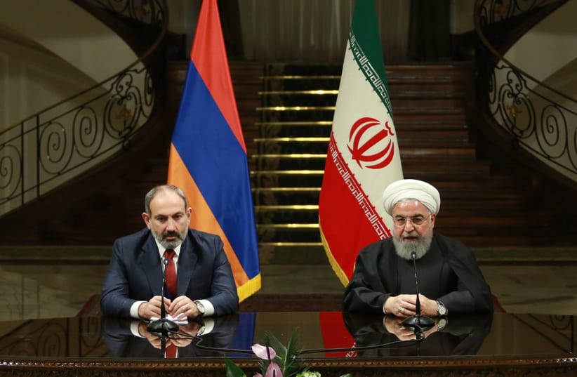 Iranian President Hassan Rouhani (R) and Prime Minister of Armenia, Nikol Pashinyan (L) hold a joint press conference following their meeting at Sadabad Complex in Tehran, Iran on February 27, 2019 (photo credit: IRANIAN PRESIDENCY HANDOUT/ANADOLU AGENCY VIA AFP)