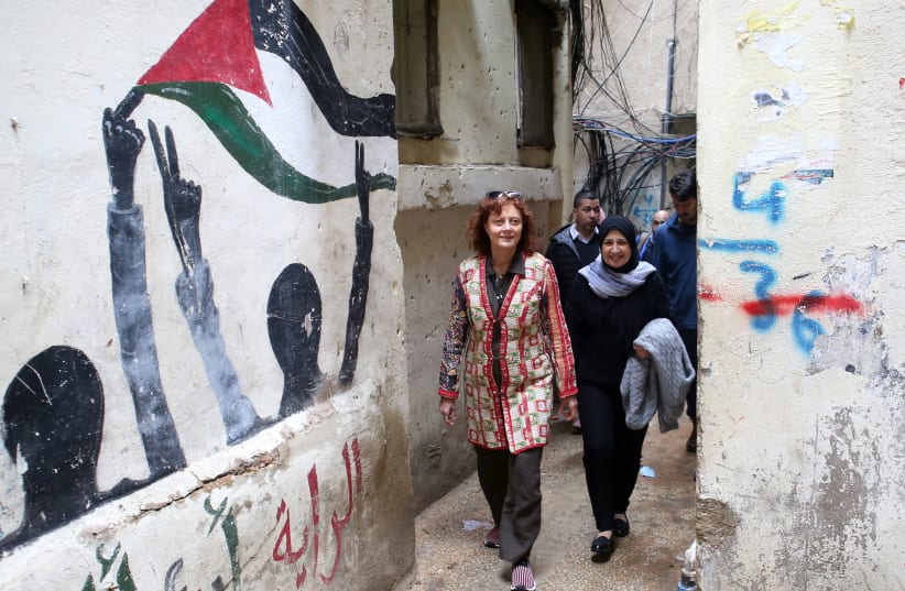 Hollywood actress and social activist Susan Sarandon walks with Mariam Shaar, a Palestinian entrepreneur in Burj al-Barajneh refugee camp in Beirut, Lebanon March 4, 2019. (photo credit: MOHAMED AZAKIR / REUTERS)