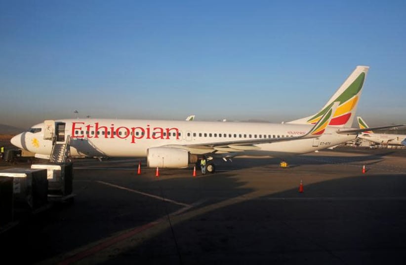 Workers service an Ethiopian Airlines Boeing 737-800 plane at the Bole International Airport in Ethiopia's capital Addis Ababa, January 26, 2017 (photo credit: REUTERS)