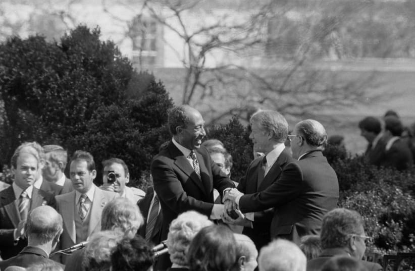 President Jimmy Carter shakes hands with Egyptian President Anwar Sadat and Israeli Prime Minister Menachem Begin at the signing of the Egyptian-Israeli Peace Treaty on the grounds of the White House, March 26, 1979 (photo credit: LIBRARY OF CONGRESS/WARREN K. LEFFLER/HANDOUT VIA REUTERS)