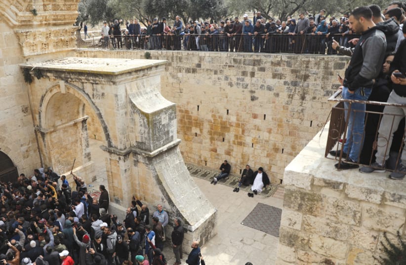 Palestinian Muslims enter the Golden Gate in Jerusalem’s Old City on February 22, 2019 (photo credit: REUTERS)