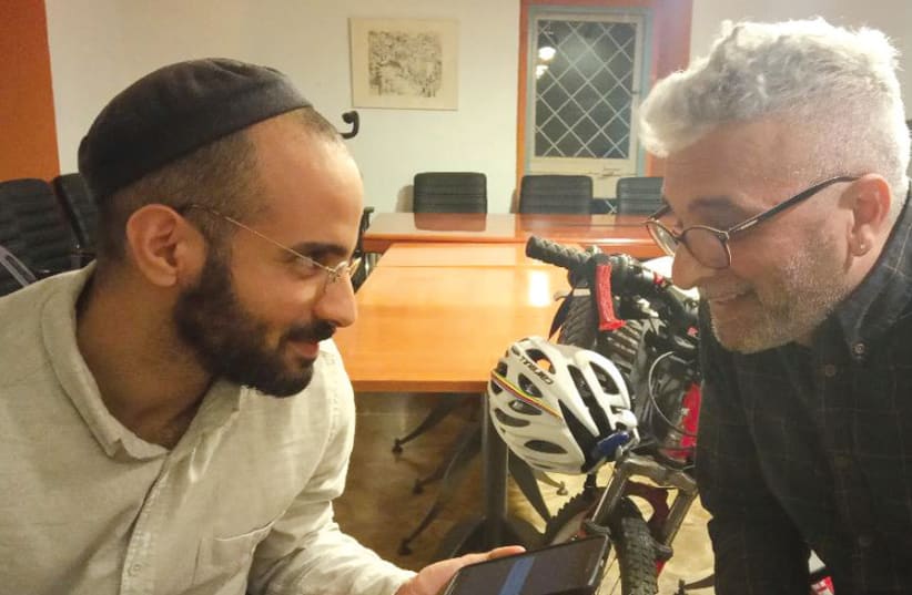 Tom Fogel (left) and Ofer Kalaf (right) listen to a recording of a Jewish woman singing in the Mughaniyyat tradition (photo credit: Courtesy)