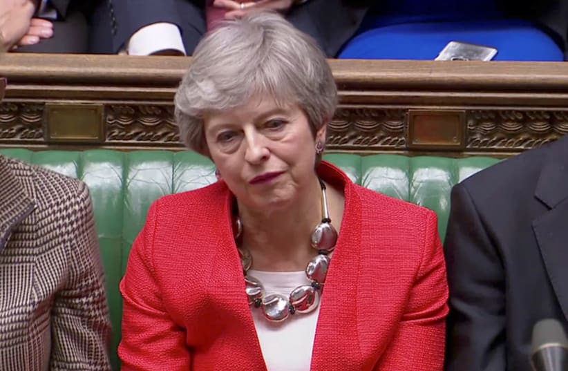 British Prime Minister Theresa May reacts after tellers announced the results of the vote Brexit deal in Parliament in London, Britain, March 12, 2019 (photo credit: REUTERS TV)