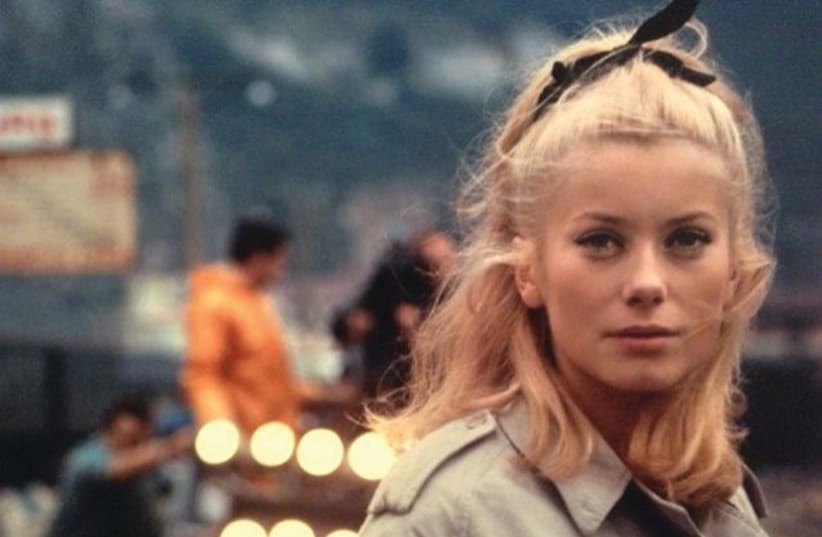 CATHERINE DENEUVE in Jacques Demy’s 1964 classic ‘The Umbrellas of Cherbourg’ (photo credit: Courtesy)