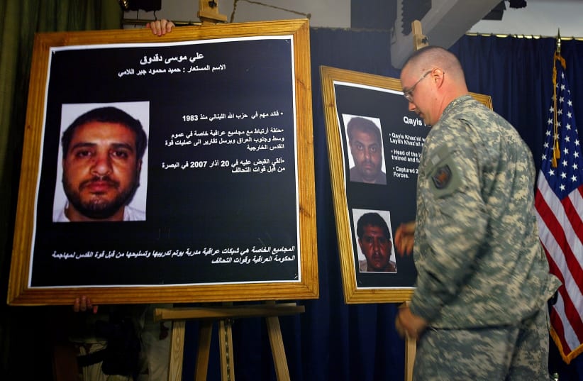 A U.S. solider shows a picture of Ali Mussa Daqduq during a news conference. (photo credit: REUTERS)