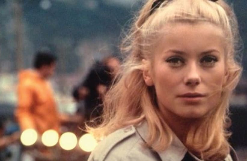 CATHERINE DENEUVE in Jacques Demy’s 1964 classic ‘The Umbrellas of Cherbourg.’ (photo credit: Courtesy)