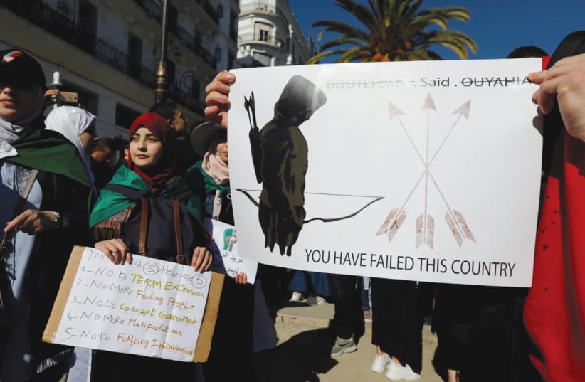 Students carry banners during a protest against Algerian President Abdelaiz Boutleflika in Algiers this week   (photo credit: ZOHARA BENSEMRA / REUTERS)