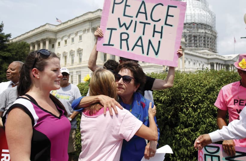 REPRESENTATIVE JAN Schakowsky (D-IL) hugs a Code Pink member at an event on Capitol Hill in Washington where activists delivered a petition in support of the Iran nuclear deal in July 2015.  (photo credit: YURI GRIPAS / REUTERS)