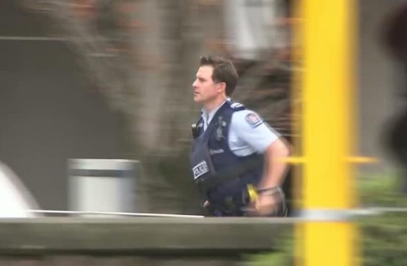 A police officer is seen after reports that several shots had been fired at a mosque, in central Christchurch, New Zealand March 15, 2019, in this still image taken from video. (photo credit: REUTERS)