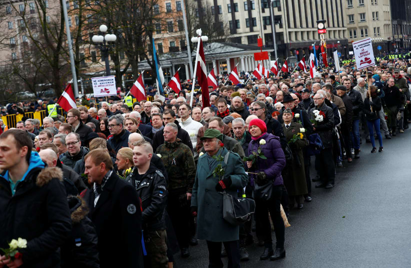 People attend the annual procession to commemorate the Latvian Waffen-SS (Schutzstaffel) unit, also known as the Legionnaires in Riga, Latvia (photo credit: REUTERS)