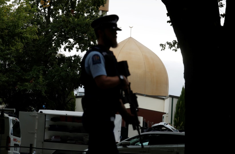 A police officer patrols outside Masjid Al Noor mosque after Friday's mosque attacks in Christchurch, New Zealand, March 16, 2019.  (photo credit: REUTERS/JORGE SILVA)