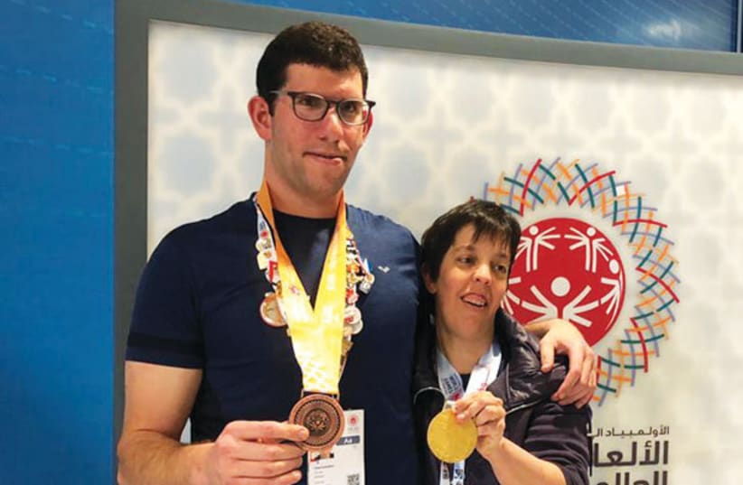 ISRAELI SWIMMERS Gilad Kalishov (left) and Avital Naveh (right) pose with the medals that they won over the weekend at the 2019 Special Olympics in Abu Dhabi (photo credit: SPECIAL OLYMPICS ISRAEL)