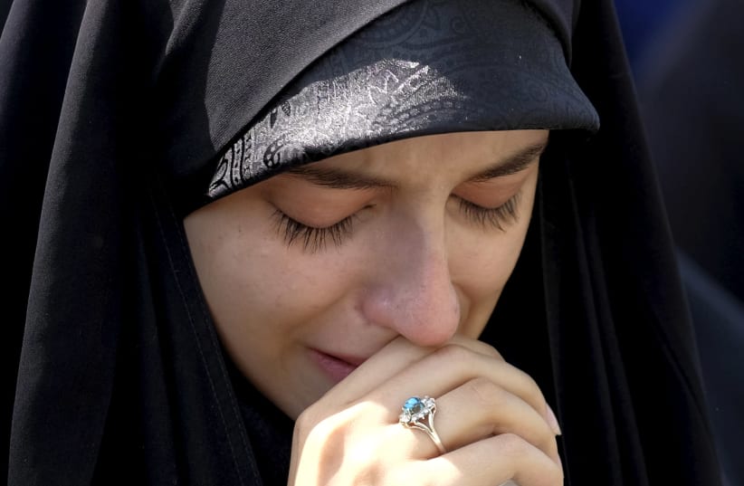 An Iranian woman mourns during the funeral of victims killed in Saudi Arabia in a stampede at the haj pilgrimage, in Tehran October 4, 2015. More than 464 Iranian nationals were killed in last month's crush in Mina, Saudi Arabia, Iran's Haj Organization says. Iranian officials have alleged the overa (photo credit: TIMA VIA REUTERS)