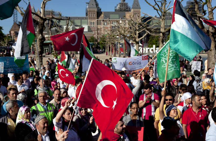 Protesters waving Turkish and Palestinian flags shout anti-Israel slogans during a demonstration in Amsterdam June 4, 2010. Israel's raid of a Gaza-bound aid flotilla has set off a diplomatic furor, drawing criticism from friends and foes alike and straining ties with regional ally Turkey, which cal (photo credit: REUTERS)