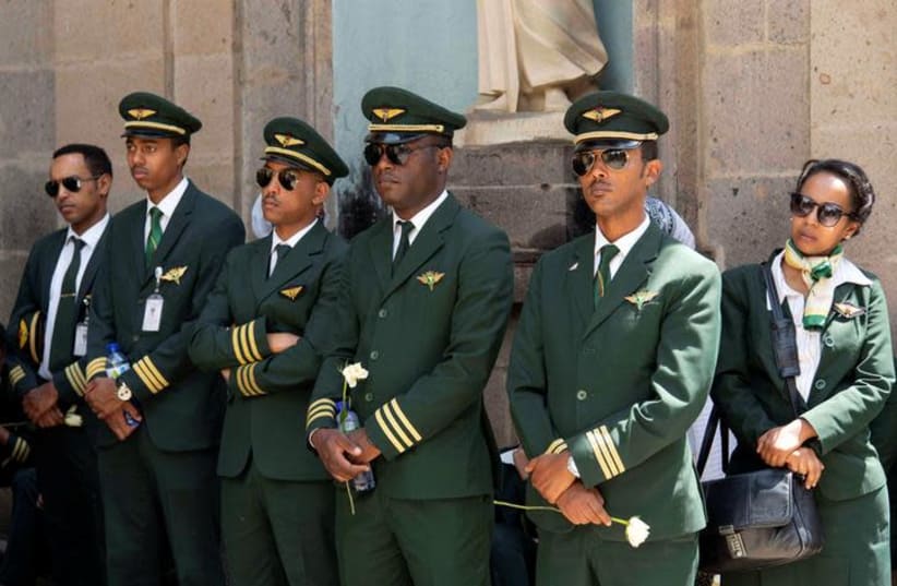 Ethiopian Airlines crew members mourn as pallbearers carry the coffins of their colleagues of the Ethiopian Airline Flight ET 302 plane crash, during the burial ceremony at the Holy Trinity Cathedral Orthodox church in Addis Ababa, Ethiopia, March 17, 2019. REUTERS/Maheder Haileselassie (photo credit: REUTERS/MAHEDER HAILESELASSIE)