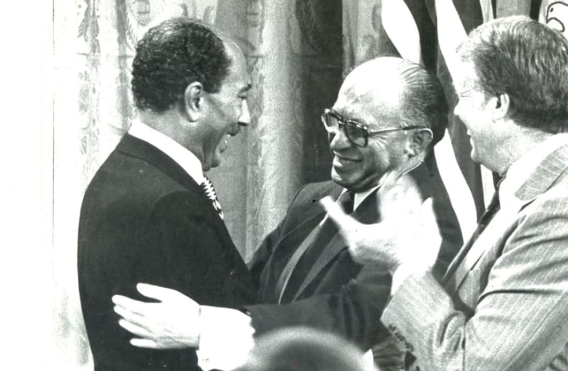 INTOXICATING DAYS: Egyptian president Anwar Sadat and prime minister Menachem Begin clasp hands with US president Jimmy Carter after the landmark ‘Framework for Peace in the Middle East’ was signed on the White House lawn. (photo credit: MOSHE MILNER / GPO)
