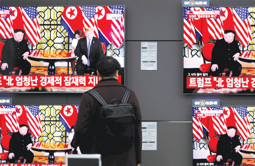 A PASSERBY watches a broadcast on the Hanoi summit between North Korean leader Kim Jong-un and US President Donald Trump, in Seoul, South Korea, on February 28. (photo credit: REUTERS)