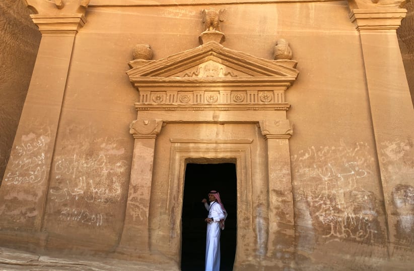 A Saudi tour guide stands inside a tomb at al-Ula (REUTERS/Stephen Kalin) (photo credit: REUTERS/STEPHEN KALIN)