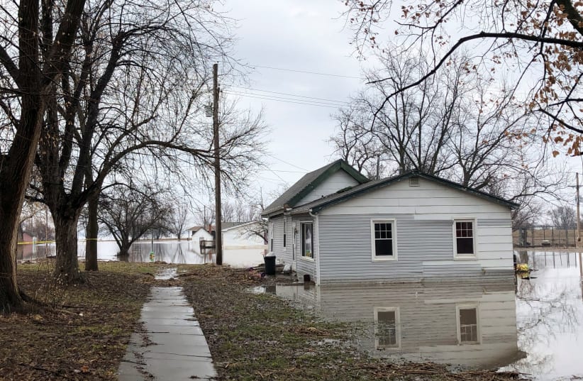 Homes sit in flood waters after leaving casualities and causing hundreds of millions of dollars in damages, with waters yet to crest in parts of the U.S. midwest, in Peru, Nebraska, U.S., March 19, 2019 (photo credit: REUTERS/KAREN DILLON)