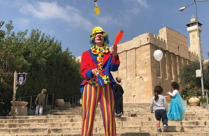 CELEBRATING PURIM outside the Tomb of the Patriarchs in Hebron (photo credit: TOVAH LAZAROFF)