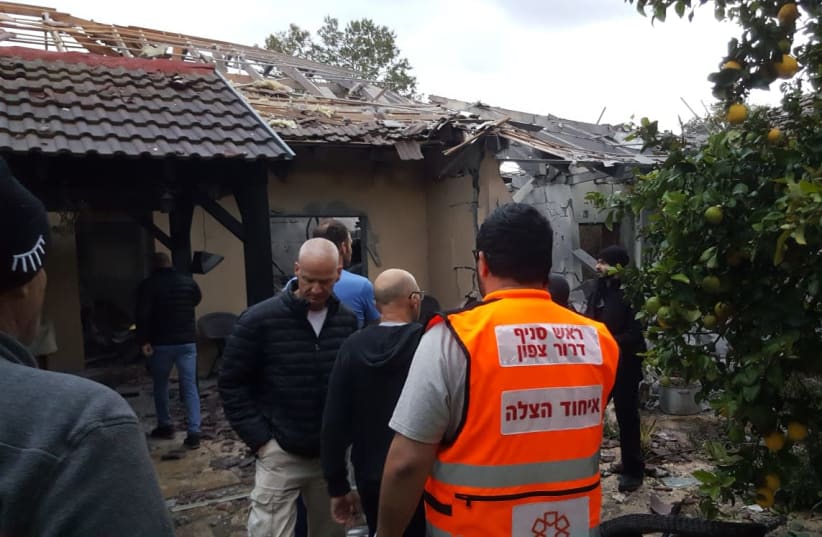 A house is taken care of by the Fire Department after being hit by rocket fire coming from the Gaza Strip, Moshav Herut, March 25, 2019. (photo credit: FIRE AND RESCUE SERVICE)