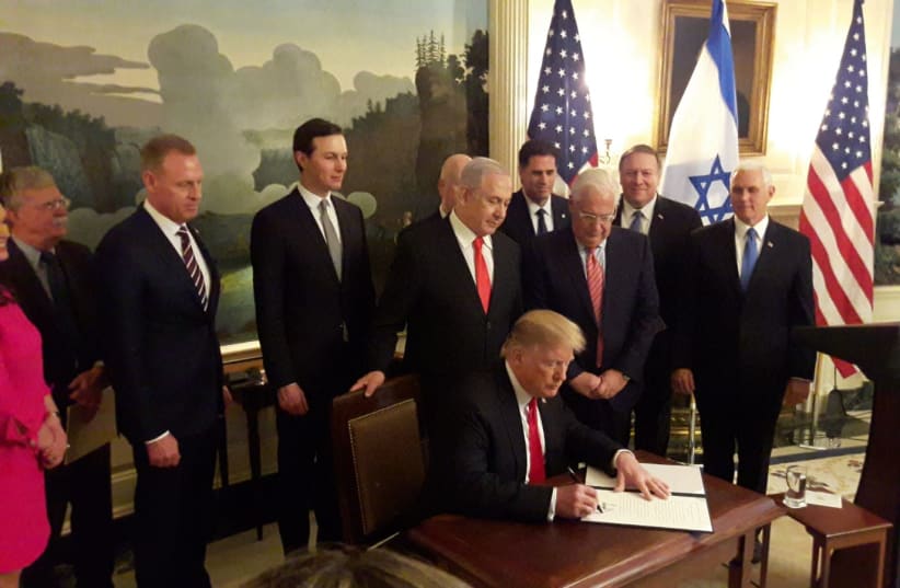 U.S. President Donald Trump signs a document recognizing Israeli control over the Golan Heights, March 25th, 2019 (photo credit: HERB KEINON)