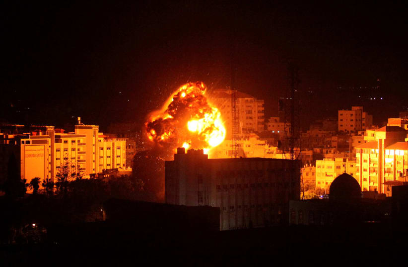 Flame and smoke are seen during an Israeli air strike in Gaza City March 25, 2019 (photo credit: MOHAMMED AJOUR/REUTERS)